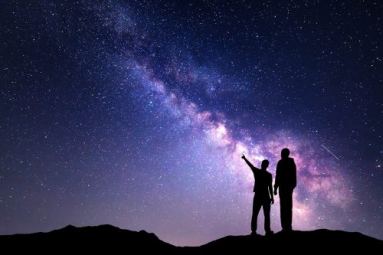 Due persone osservano un cielo stellato