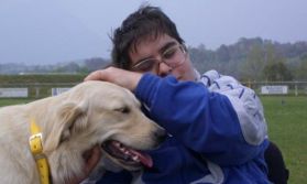 Ragazzo con disabilità insieme a un cane labrador