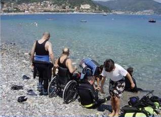 Persone con disabilità in riva al mare, pronte ad immergersi